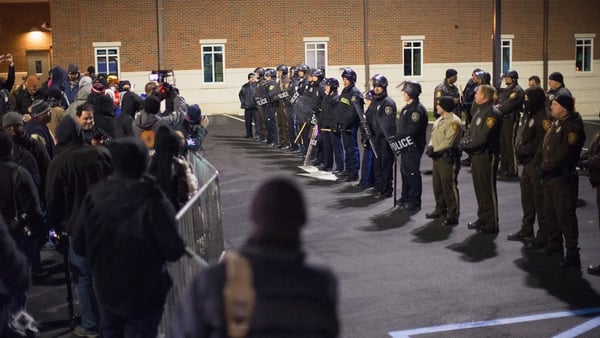 Police in Ferguson confront demonstrators protesting the death of Michael Brown