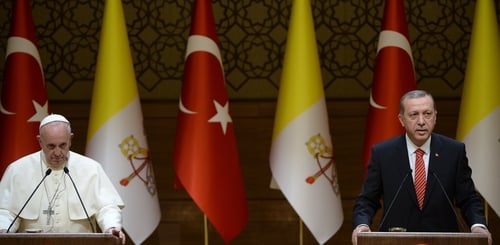Pope Francis listens to the speech of Turkish President Recep Tayyip Erdogan during their meeting in Ankara