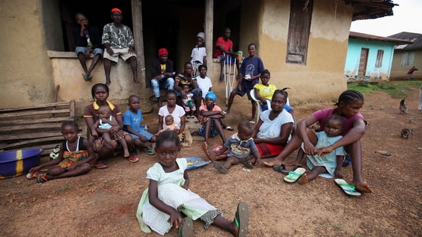 People under quarantine due to the death of over 20 locals from Ebola gather in Jene Wonde, Liberia