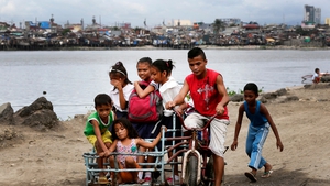 Students on their way home in anticipation of strong winds in a slum area in Baseco district, Manila