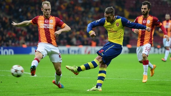 Lukas Podolski slots home Arsenal's fourth in Istanbul