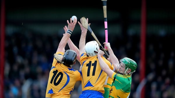 Gort's Michael Cummins contests a high ball against Kevin Hayes and Niall Hayes of Portumna