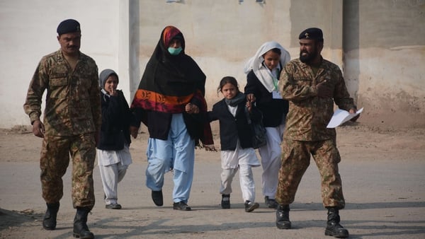 Children are led to safety from the Army Public School