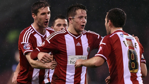 Masked man Marc McNulty celebrates his goal with his Sheffield United team-mates