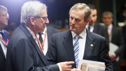 Enda Kenny speaks with European Commission President Jean-Claude Juncker at the EU summit