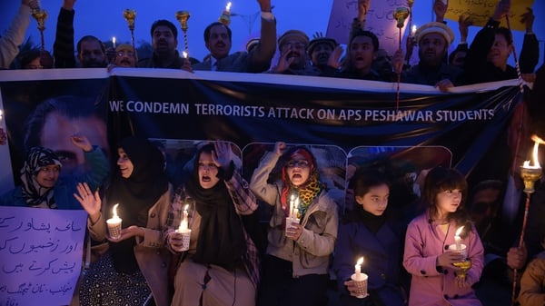 Pakistani lawyers and civil society activists hold lighted candles during a vigil in Islamabad