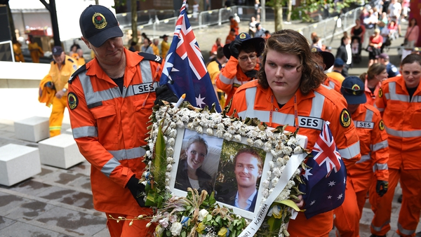 State Emergency Service workers remove a tribute to the victims of the Sydney Lindt cafe siege