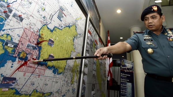The Indonesian navy's Admiral Abdul Rashid points to a search area on a map