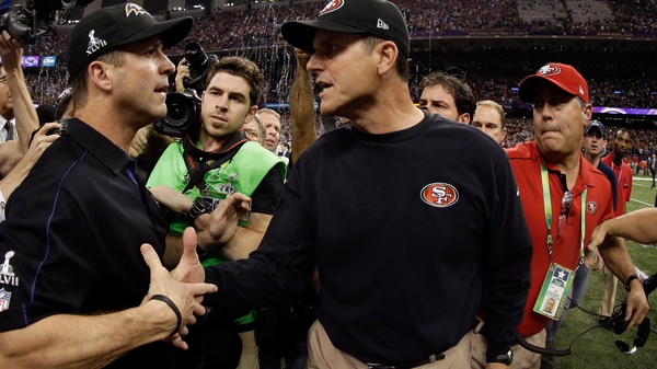 Jim Harbaugh (C) pictured with his brother John (L) after the San Francisco 49ers lost Super Bowl XLVII