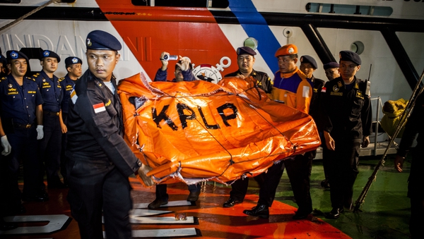 Indonesia Sea and Coast Guard carry seats recovered from AirAsia flight QZ8501