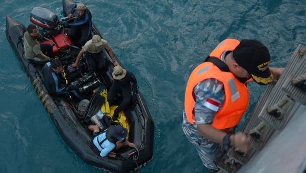 Indonesian Navy divers prepare to conduct operations to lift the tail of AirAsia flight QZ8501 in the Java Sea