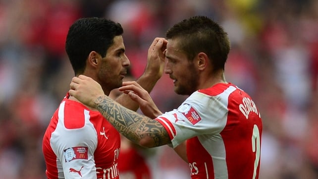 Mikel Arteta embraces Mathieu Debuchy during happier times