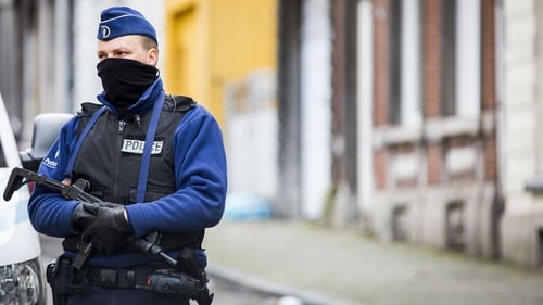 An armed Belgian officer patrols a street in Verviers, one day after two suspected jihadists were killed in a police raid