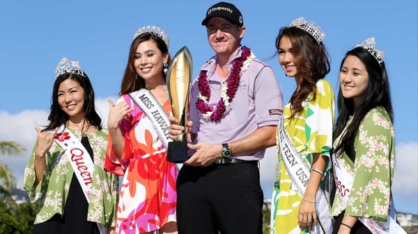 Jimmy Walker celebrates with the winner's trophy at Waialae Country Club