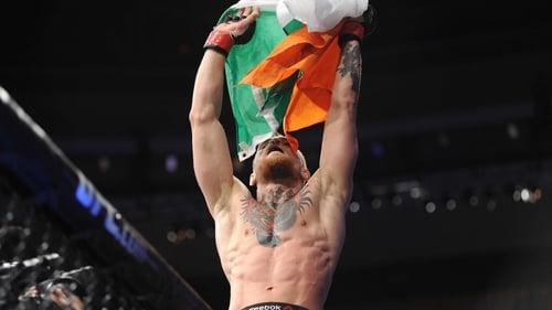 Conor McGregor raises the tri-colour in victory
