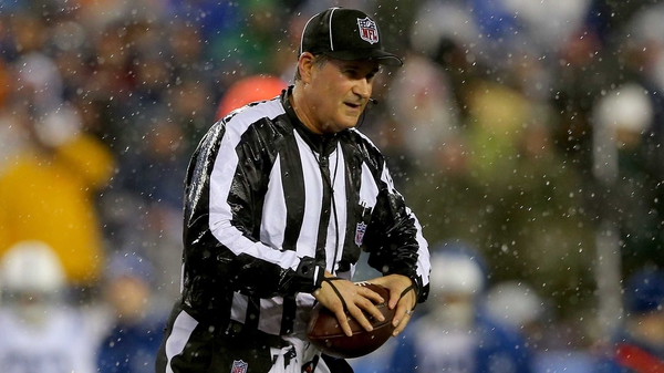 Umpire Carl Paganelli with one of the balls in question during the match between the New England Patriots and the Indianapolis Colts