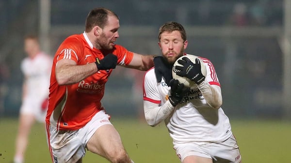 Armagh's Mark McConville with Tyrone's Peter Hughes