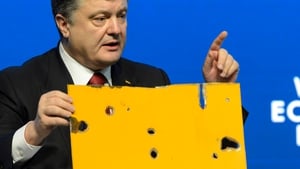 The Ukrainian president holds up a piece of the bus destroyed in today's attack at the World Economic Forum in Davos