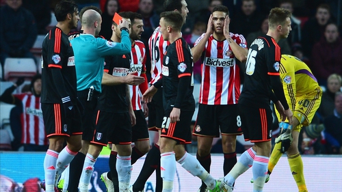 Jack Rodwell of Sunderland stands in shock as the midfielder is shown a red card
