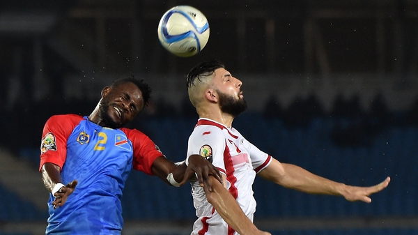 Tunisia's Youssef Msakni (R) goes for a header with DR Congo's Issama Mpeko