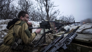 A pro-Russian separatist fires his machine gun towards Ukrainian army positions near Debaltseve