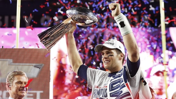New England Patriots quarterback Tom Brady celebrates with the Vince Lombardi Trophy