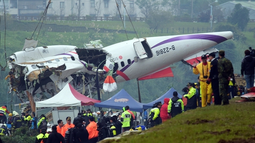 A crane is used to lift the plane wreckage from the river