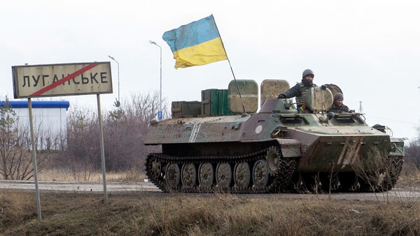 A tank carrying the Ukrainian flag is seen near the town of Lugansk