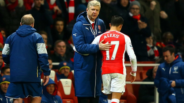 Arsene Wenger consoles Alexis Sanchez after the Chilean suffered a knee injury