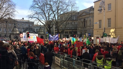 Around 1,000 people involved in the childcare sector have assembled outside Leinster House