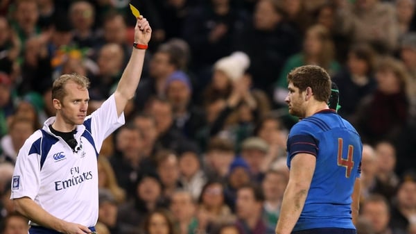 Referee Wayne Barnes shows Pascal Papé of France a yellow card following the incident
