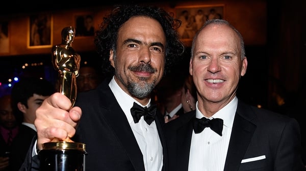 Writer-director Alejandro Gonzalez Iñárritu and Birdman star Michael Keaton celebrate their film's quadruple win