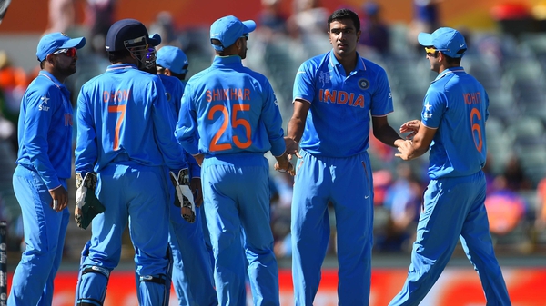 Ravichandran Ashwin receives the congratulations of his India team-mates after after taking the wicket of Krishnachandran Karate