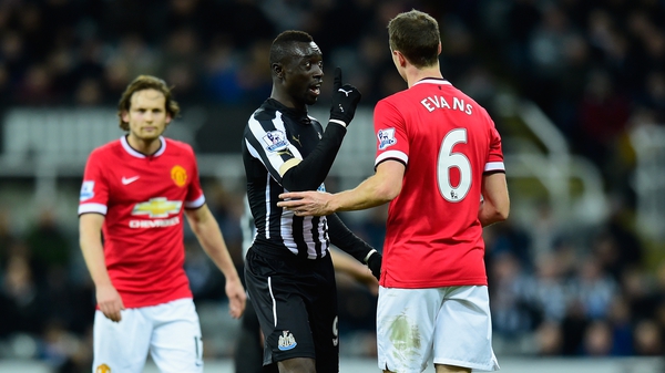 Newcastle's Papiss Cisse (L) confronts Manchester United's Jonny Evans