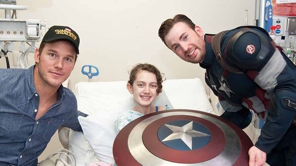 Chris Pratt and Chris Evans with a patient at Seattle Children's Hospital who looks delighted to see them