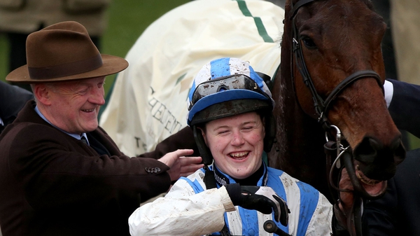 Willie Mullins celebrates winning with Luke Dempsey (R) after Killultagh Vic's victory