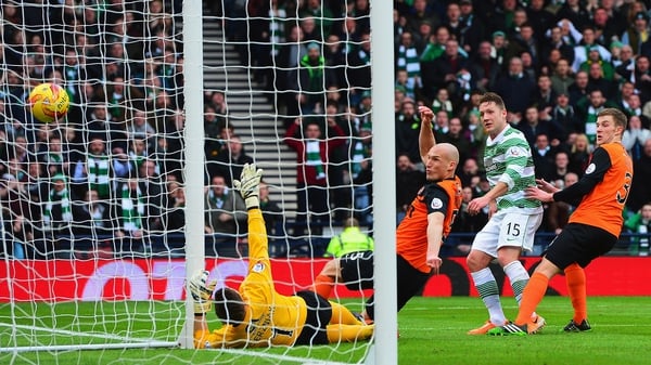 Kris Commons of Celtic scores the opening goal of the game