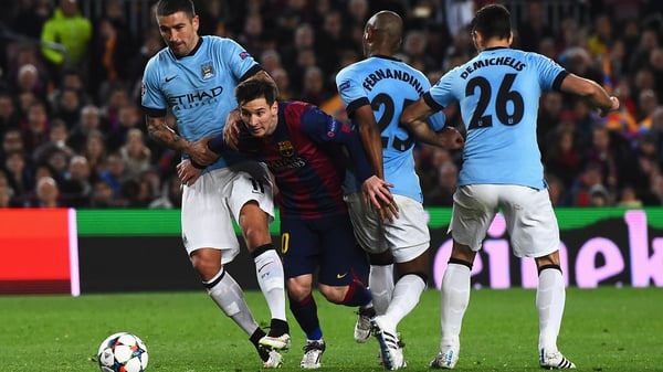 Lionel Messi of Barcelona breaks past Aleksandar Kolarov, Fernandinho and Martin Demichelis during Man City's Champions League exit at the Nou Camp