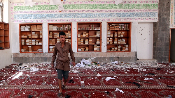 A man inspects the damage of a bomb blast at a mosque in Sanaa, Yemen