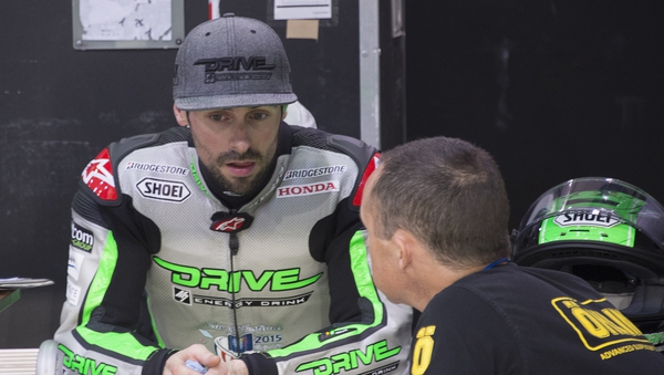 Eugene Laverty speaks with mechanics during the MotoGP tests in Qatar