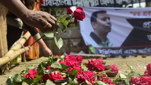 People leave flowers as a mark of respect for murdered blogger Avijit Roy in Dhaka on 6 March
