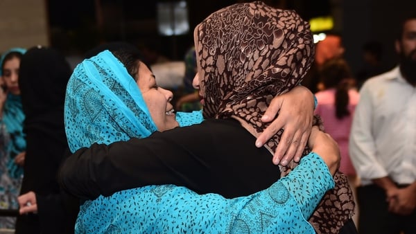 One of more than 500 Pakistani citizens evacuated from Yemen (R) greets a relative upon arrival in Islamabad