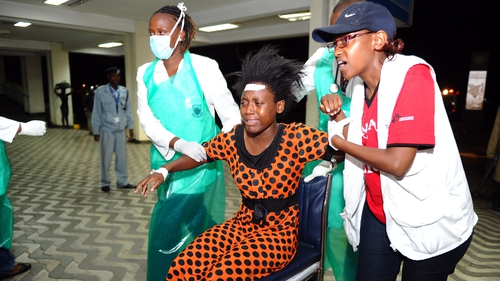 Paramedics attend to an injured Kenyan student as she is wheeled into Kenyatta National Hospital in Nairobi
