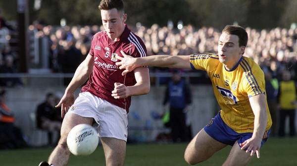 Galway's Dylan Corbett (L) get his shot off ahead of a challenge from Roscommon's Conor Hussey