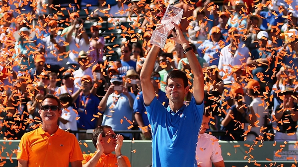 Novak Djokovic of Serbia holds aloft the Butch Bucholz trophy