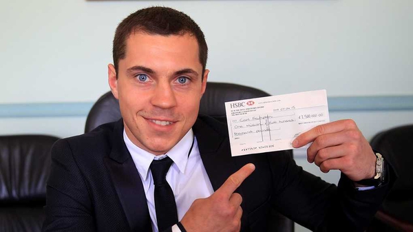Scott Quigg holding the proposed offer for Carl Frampton