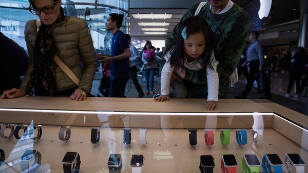 People look at Apple Watches at a store in Hong Kong