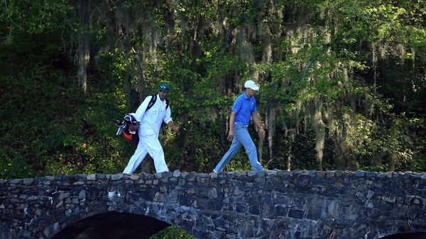 Jordan Spieth and his caddie walk over the Nelson Bridge on the 13th hole at Augusta