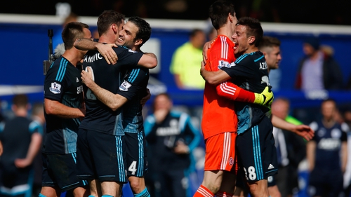 Chelsea players celebrate after their last-gasp win over QPR