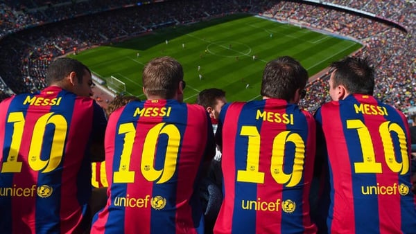 Messi fans pictured at a recent Barcelona encounter. The shirts will be worn again tonight with pride and hope